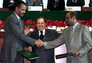 Algerian President Abdelaziz Bouteflika (C) stands between Eritrean President Isayas Afewerki (L) who shakes hands with Ethiopian Prime Minister Meles Zenawi (R) after signing peace agreements December 12, 2000. Ethiopia and Eritrea formally ended their two-year border war after months of mediation by the Organisation of African Unity (OAU), the United Nations and the United States.